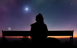 Girl watching the Moonrise on a starry skies.